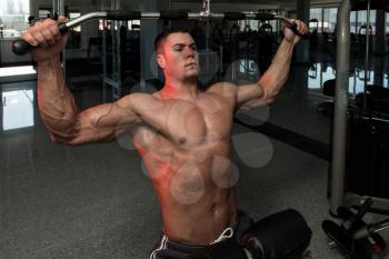 Young Bodybuilder Doing Heavy Weight Exercise For Back