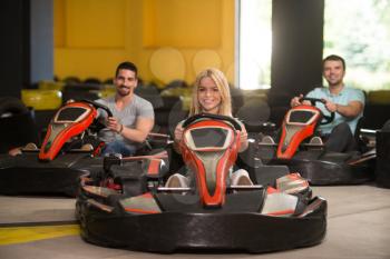 Group Of People Is Driving Go-Kart Car With Speed In A Playground Racing Track - Go Kart Is A Popular Leisure Motor Sports