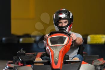 Young Man Is Driving Go-Kart Car With Speed In A Playground Racing Track - Go Kart Is A Popular Leisure Motor Sports