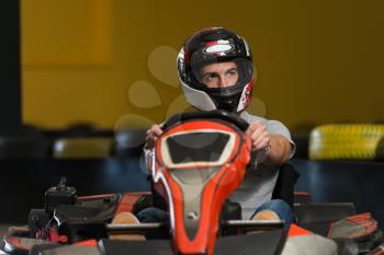 Young Man Is Driving Go-Kart Car With Speed In A Playground Racing Track - Go Kart Is A Popular Leisure Motor Sports