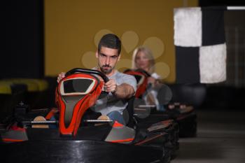 Group Of People Is Driving Go-Kart Car With Speed In A Playground Racing Track - Go Kart Is A Popular Leisure Motor Sports