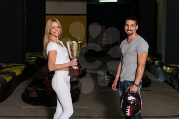 Young Woman Gives Man A Cup Speed Karting Race