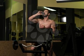 Muscular Man Resting After Exercise And Drinking Water