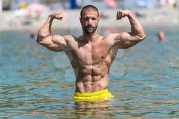 Portrait Of A Very Muscular Sexy Man In Underwear At Swimming Pool Showing Biceps