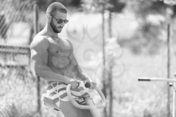 Handsome Muscular Young Man - Training On The Playground In Park