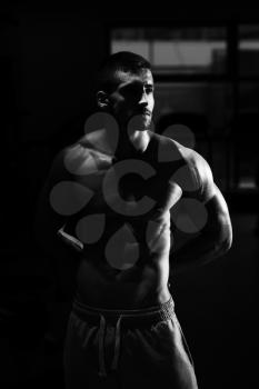 Athlete Muscular Brutal Bodybuilder Emotional Posing In A Dark Gym