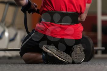 Bodybuilder Prepairing For Deadlift Putting Straps For Safety