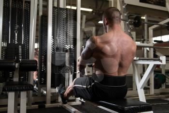 Bodybuilder Doing Back Exercises In The Gym