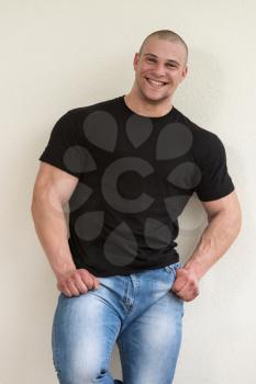Happy Muscular Man In Black T-Shirt Standing And Showing His Muscle