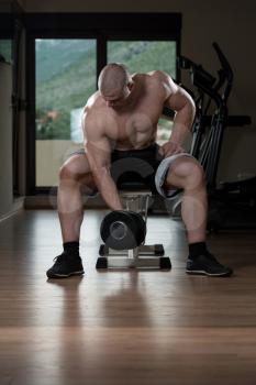 Bodybuilder Doing Heavy Weight Exercise For Biceps With Dumbbells In Gym