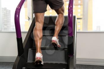 Close Up Of Male Legs Exercise On Stepper