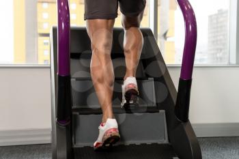 Close Up Of Male Legs Exercise On Stepper