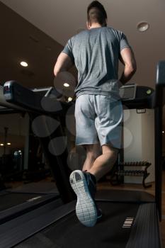 Close Up Of Male Legs Running On Treadmill - Blurred Motion