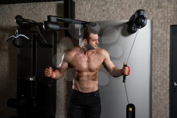 Young Man Is Working On His Chest With Cable Crossover In A Modern Fitness Gym