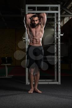 Portrait Of A Young Physically Fit Man Showing His Well Trained Abdominal Muscles - Muscular Athletic Bodybuilder Fitness Model Posing After Exercises