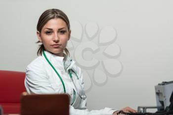 Young Pretty Female Doctor With Computer In The Office - Successful Woman Doc At Work
