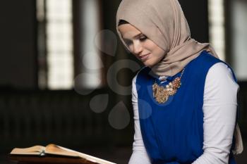 Humble Muslim Woman Is Reading The Koran In The Mosque