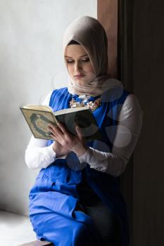 Humble Muslim Woman Is Reading The Koran In The Mosque