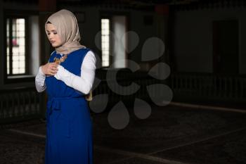 Humble Muslim Woman Is Praying In The Mosque