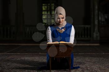 Humble Muslim Woman Is Reading The Koran In The Mosque