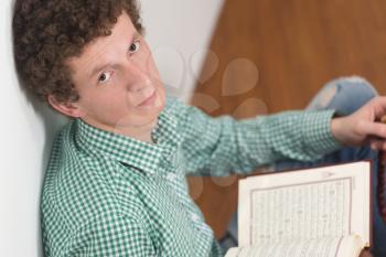 White Muslim Man Is Reading The Koran In The Mosque - Afro Lock Hair Curly