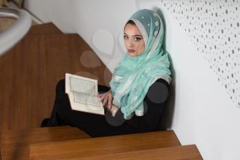 Beautiful Muslim Woman Wearing Hijab And Reading The Koran