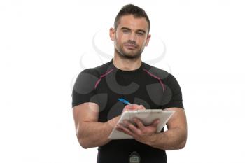 Handsome Personal Trainer With A Clipboard Isolated On A White Background