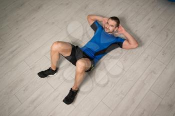 Personal Trainer Performing Abdominal Exercise On Floor - One Of The Most Effective Ab Exercises