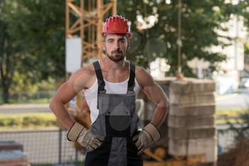 Portrait Of Handsome Male Architect Engineer With Red Helmet