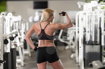 Portrait Of A Young Physically Fit Woman Showing Her Well Trained Body - Muscular Athletic Bodybuilder Fitness Model Posing After Exercises