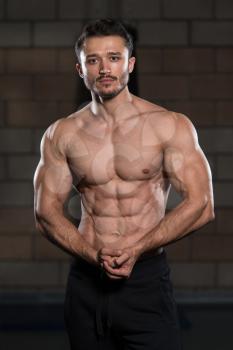 Portrait Of A Young Physically Fit Man Showing His Well Trained Body - Muscular Athletic Bodybuilder Fitness Model Posing After Exercises