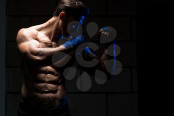 Handsome Man In Blue Boxing Gloves - Boxing In Gym - The Concept Of A Healthy Lifestyle - The Idea For The Film About Boxing