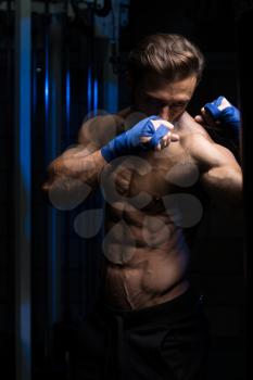 Handsome Man In Blue Boxing Gloves - Boxing In Gym - The Concept Of A Healthy Lifestyle - The Idea For The Film About Boxing