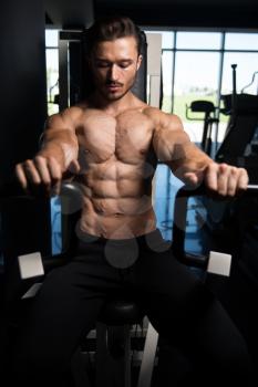 Handsome Bodybuilder Doing Heavy Weight Exercise For Chest On Machine