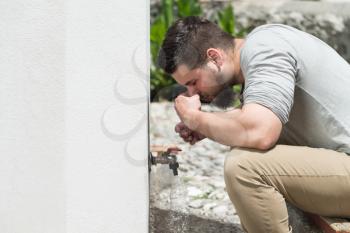 Muslim Man Preparing To Take Ablution In Mosque