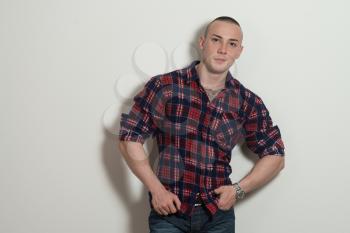 Portrait of a Successful Young Man Standing Isolated on Grey Background