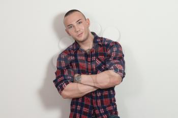 Portrait of Handsome Man With Crossed Hands Over Gray Background