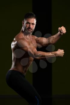 Portrait Of A Young Physically Fit Man Showing His Well Trained Body - Muscular Athletic Bodybuilder Fitness Model Posing After Exercises