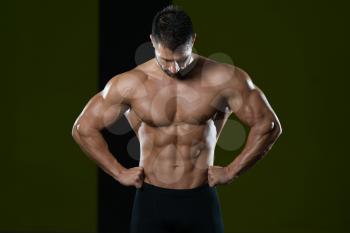 Healthy Man Standing Strong In The Gym And Flexing Muscles - Muscular Athletic Bodybuilder Fitness Model Posing After Exercises