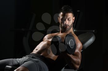 Handsome Man Working Out Biceps In A Dark Gym - Dumbbell Concentration Curls