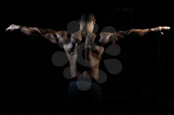 Healthy Man Standing Strong In The Gym And Flexing Muscles - Muscular Athletic Bodybuilder Fitness Model Posing After Exercises