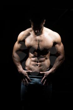 Healthy Man Standing Strong In The Gym And Flexing Muscles - Muscular Athletic Bodybuilder Fitness Model Posing After Exercises