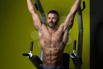 Muscular Man Performing Hanging Leg Raises Exercise - One Of The Most Effective Ab Exercises