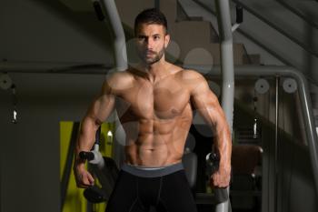 Healthy Man Standing Strong In The Gym And Flexing Muscles - Muscular Athletic Bodybuilder Fitness Model Posing After Exercises