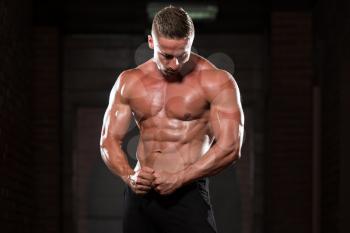 Portrait Of A Young Physically Fit Man Showing His Well Trained Body - Muscular Athletic Bodybuilder Fitness Model Posing After Exercises