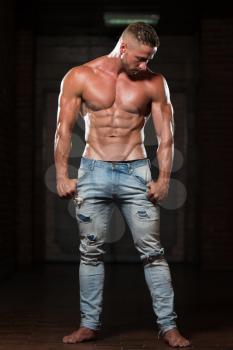 Portrait Of A Young Physically Fit Man In Jeans Showing His Well Trained Body - Muscular Athletic Bodybuilder Fitness Model Posing After Exercises