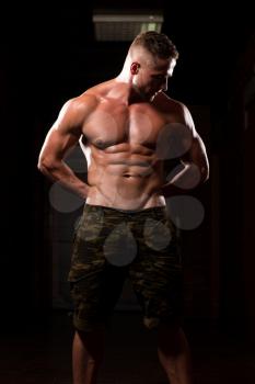 Portrait Of A Young Physically Fit Man Showing His Well Trained Body - Muscular Athletic Bodybuilder Fitness Model Posing After Exercises