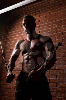 Young Bodybuilder Is Working On His Chest With Cable Crossover In Gym