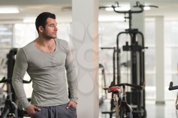 Portrait of a Young Physically Fit Man in Green T-shirt Long Sleevs Showing His Well Trained Body - Muscular Athletic Bodybuilder Fitness Model Posing After Exercises