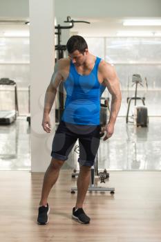 Portrait Of A Young Physically Fit Man In Blue Undershirt Showing His Well Trained Body - Muscular Athletic Bodybuilder Fitness Model Posing After Exercises